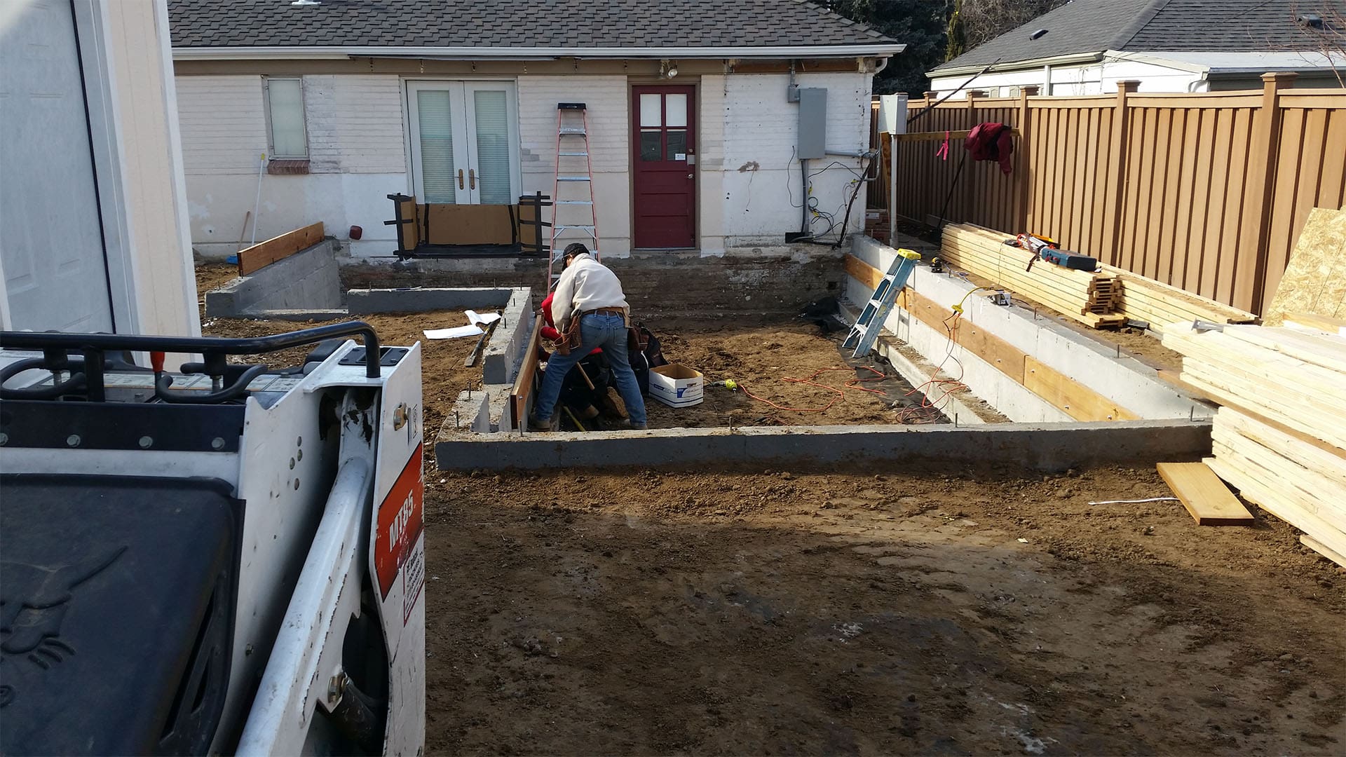 Crawl space foundation excavation and concrete footings for home addition in Denver